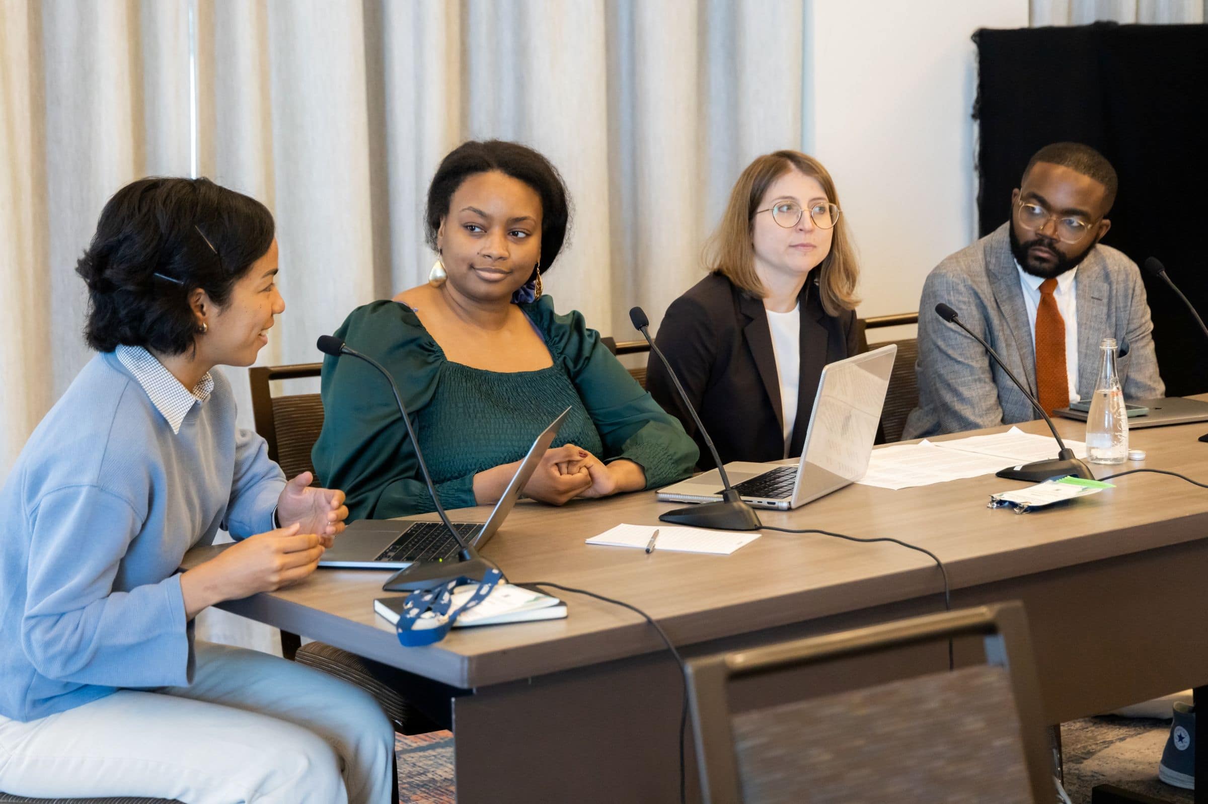 1P4A2855v2 Seated participants discussing at a conference table