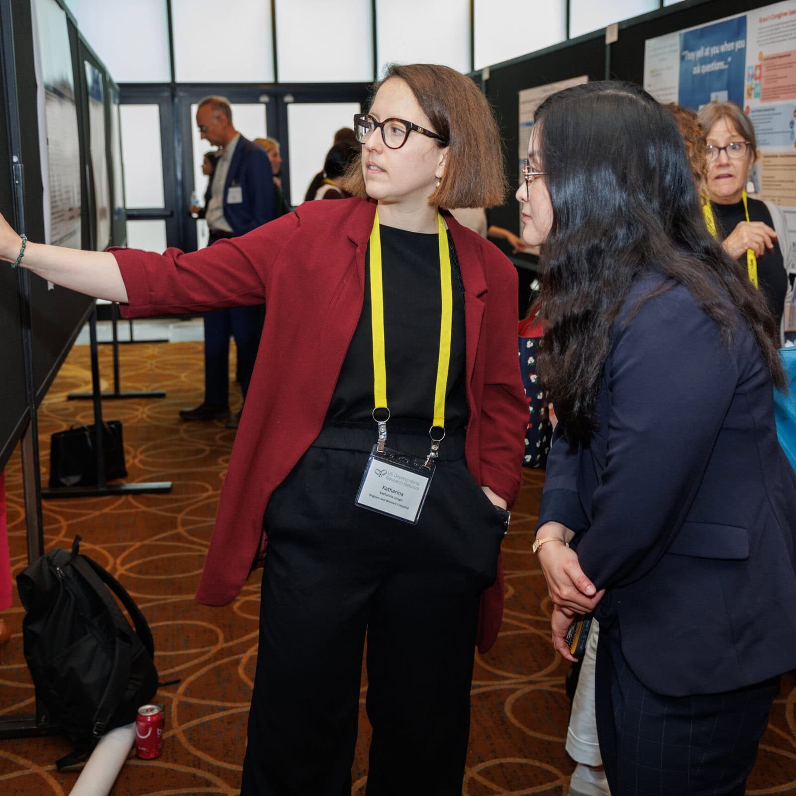 Two women looking at a poster closely