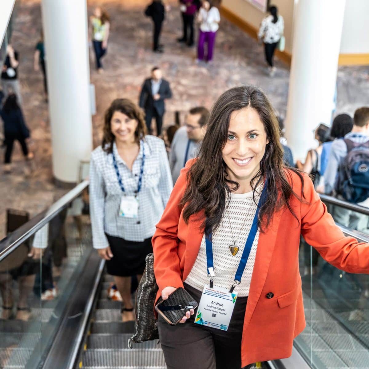 Conference attendees coming up an escalator