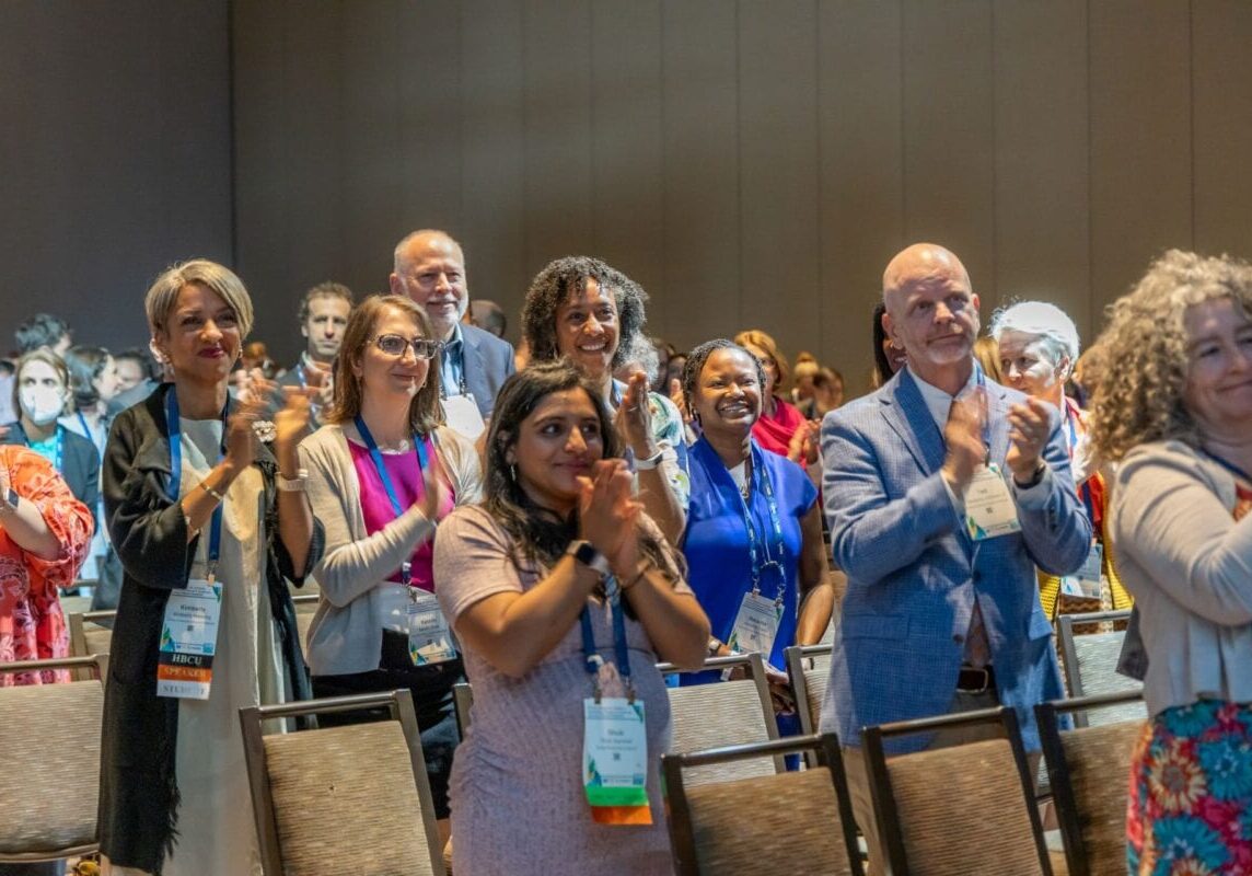 Standing ovation, meeting attendees standing and clapping